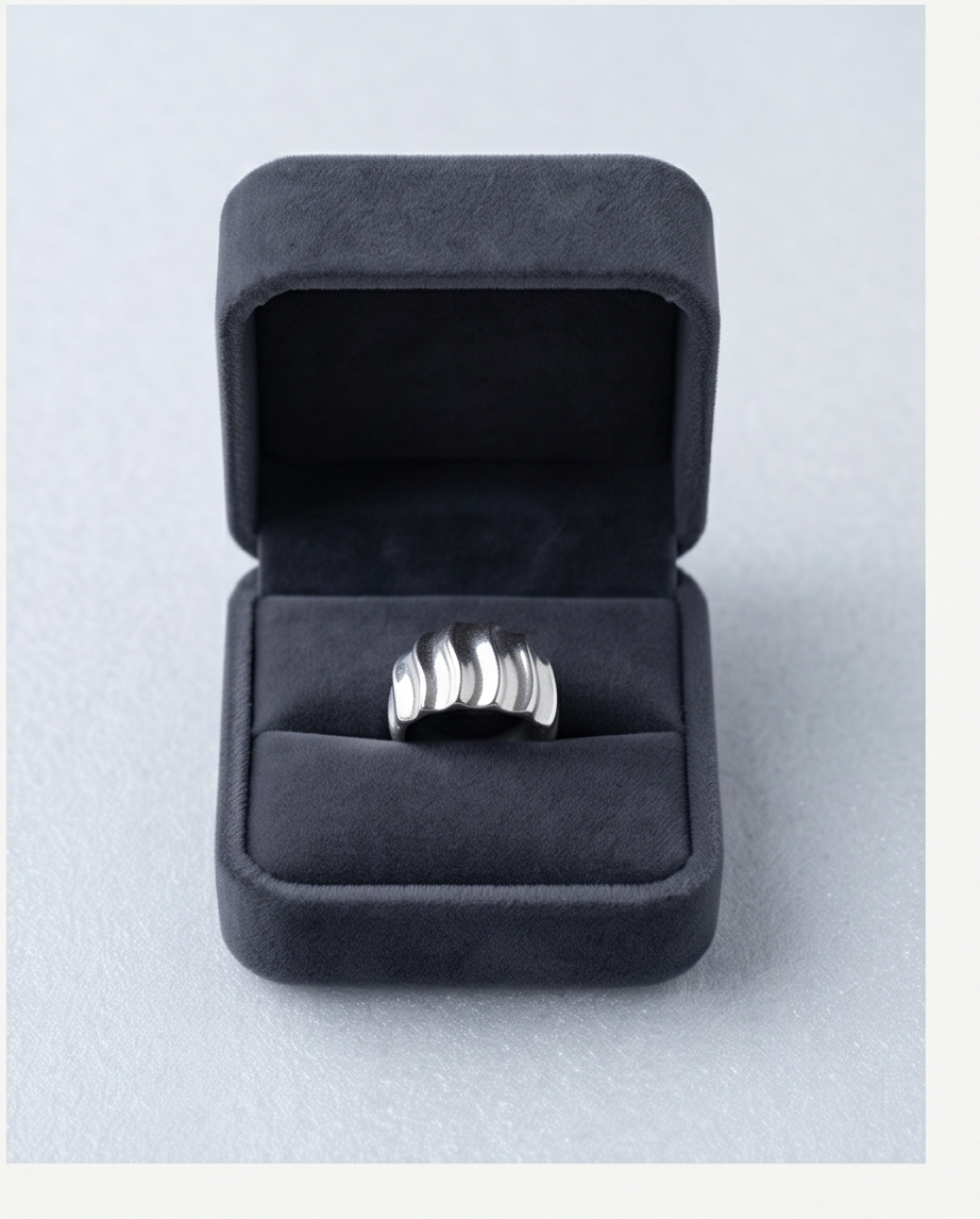 Model wearing silver wave dome ring with beige satin outfit