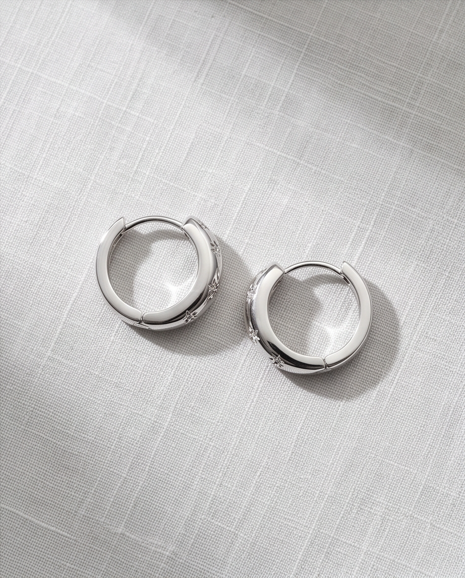 Silver Celestial Star Hoop Earrings — pair on white satin