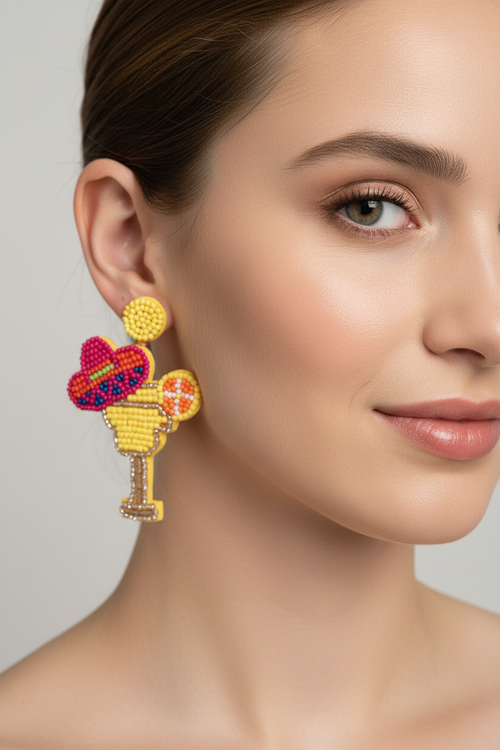 Close-up of model's jawline wearing beaded cocktail glass and sombrero earrings
